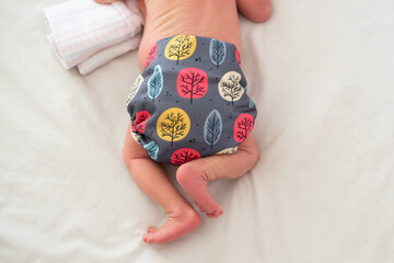 A photo of a baby's cloth diaper while she is lying on her tummy