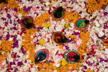 Floor decorated with diyas and flowers on the occasion of diwali