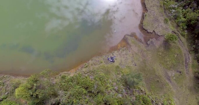 Pristine Green Guarne Lagoon in the Middle of the Woods near Medellin, Colombia on a Cloudy Day shot from in Smooth Travelling form Above