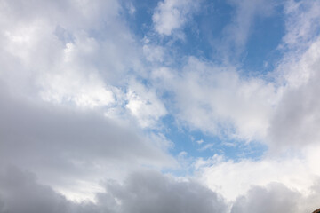 Naklejka na ściany i meble Blue sky with a white and grey cloud