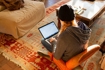 teenage girl using her laptop early morning