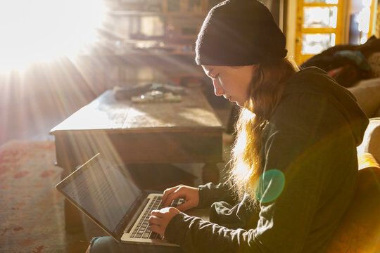 teenage girl using her laptop early morning