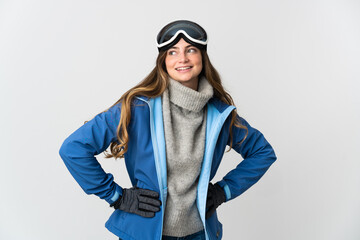 Skier girl with snowboarding glasses isolated on white background posing with arms at hip and smiling