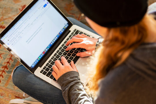 teenage girl using her laptop early morning
