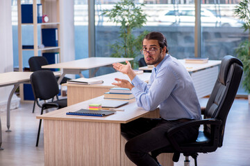 Young male teacher in the classroom