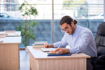 Young male teacher in the classroom