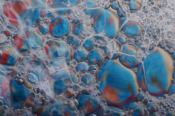 blurry abstract background of colored soap bubbles in water