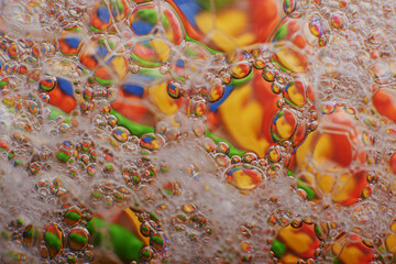 Fototapeta na wymiar blurry abstract background of colored soap bubbles in water