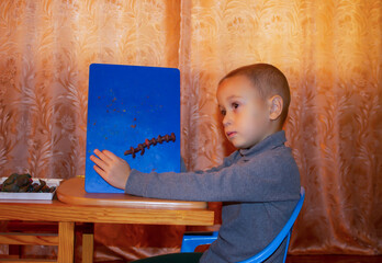 boy playing with plasticine at home