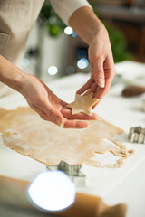 Woman in apron preparing Christmas ginger cookies.