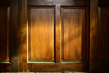The rays of the setting sun shone on a wooden door.
