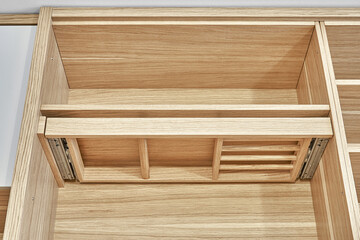 Modern wardrobe with slide out rack for coathangers. Detail of modern furniture