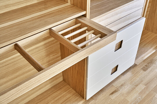 Modern wardrobe with slide out rack for coathangers. Detail of modern furniture