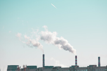 copy space with industrial chimneys with smoke on blue sky background. Smokestack Pollution in the...