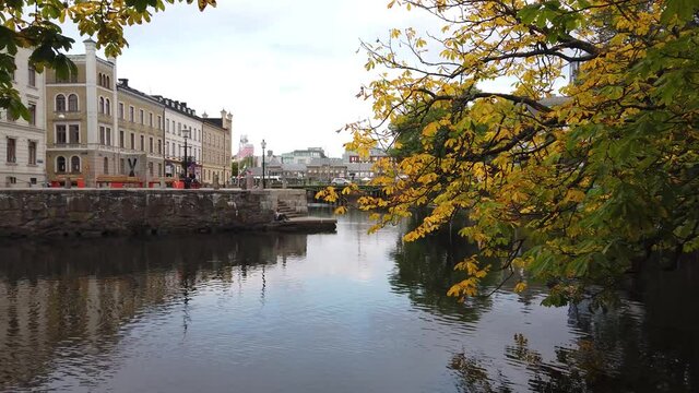 Autumn canal scene with branches hanging over the water, Gothenburg, Sweden