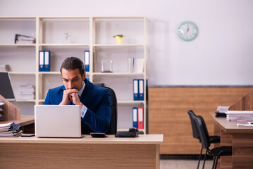 Young male employee working in the office