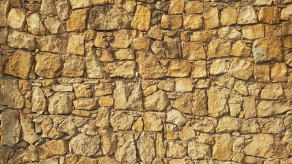 A  Yellow Stone Wall for Backgrounds Backdrops or Copy Space
