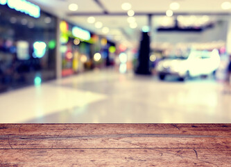 Empty wood table top on blur abstract shopping mall background. can be used for display or montage your products