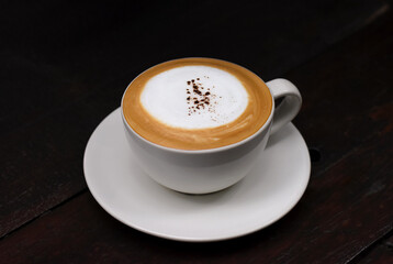 Cup of coffee on old wooden background.
