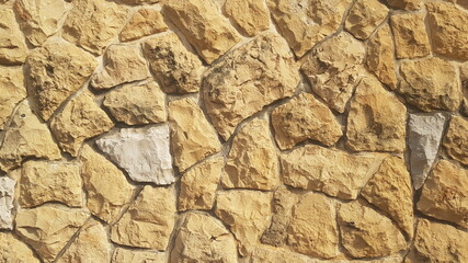 A  Yellow Stone Wall for Backgrounds Backdrops or Copy Space
