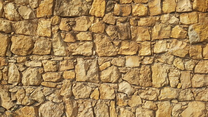 Obraz premium A Yellow Stone Wall for Backgrounds Backdrops or Copy Space 
