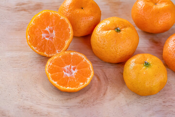 orange on wooden table close up