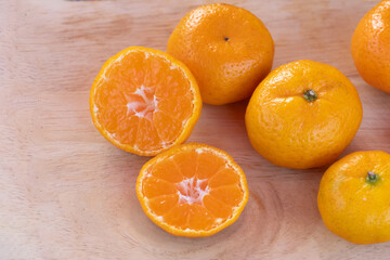orange on wooden table close up