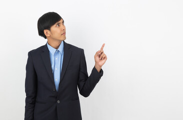 Young handsome asian business man pointing to the side with doubts face isolated on white background.