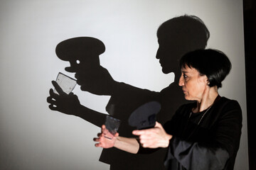 play shadow projected against a white background. a cook