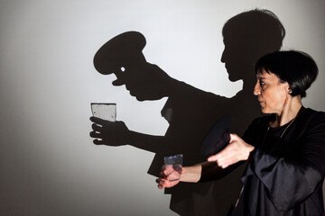 play shadow projected against a white background. a cook