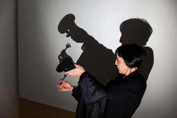play shadow projected against a white background, a cook