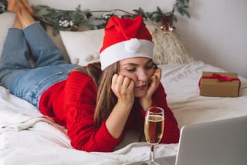 A sad girl with laptop. Self-isolation during New Years and Christmas. 