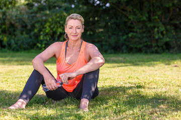 Outdoor Portrait of Attractive Middle Aged Woman Exercising