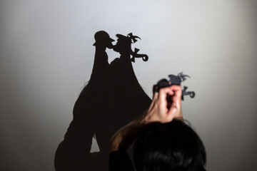 play shadow projected against a white background. two little people