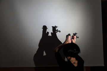 play shadow projected against a white background. two little people