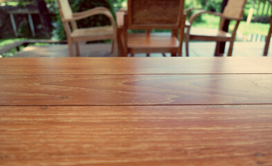 Empty wood table top on blur abstract green from garden in morning background. can be used for display or montage your products