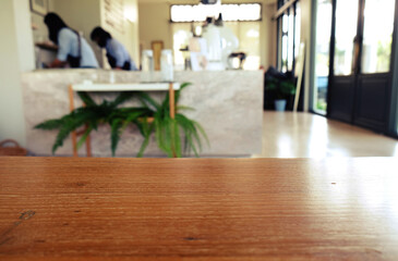 wood table on blur of cafe, coffee shop, bar, resturant, background - can used for display or montage your products