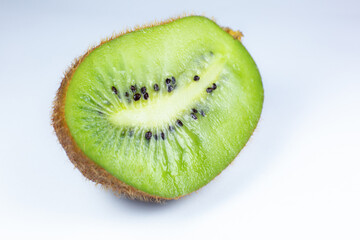 Close up photo of kiwi on white background. Kiwi fruit cut in half with seeds inside, macro view.
