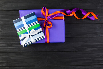 Different colors and sizes gift box on wooden table
