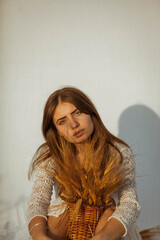 Portrait of a woman in white dress on white background and in nature