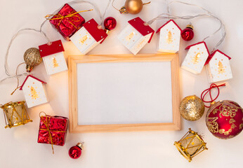 Christmas wooden frame mocap. Christmas balls, garlands, red and gold decorations on a white background. Flat lay, top view, copy space
