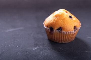 Muffin with cherries. One muffin in a white box.