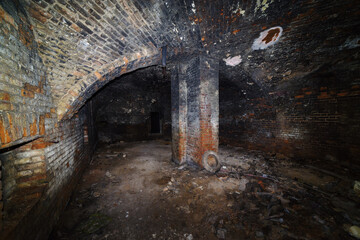 The basement of an old house with a domed vault and a supporting column. The picture was taken in Russia, in Orenburg