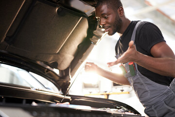 black african auto mechanic does not understand how to troubleshoot the machine, he has no tools...