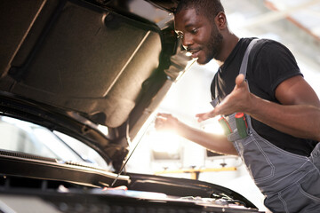 black african auto mechanic does not understand how to troubleshoot the machine, he has no tools for repair. misunderstanding