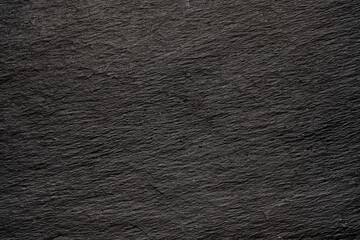Dark gray black slate background or natural stone texture. Black board for serving close-up.