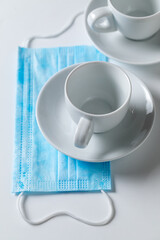 Medical mask and coffee as restaurant restrictions in a pandemic