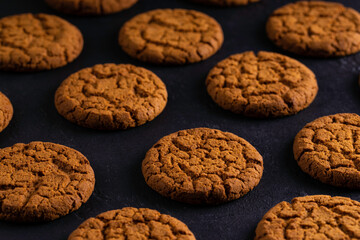 Breakfast with healthy oatmeal cookies. Homemade cookies on dark background.