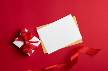 Greeting card mockup with gift box on red background