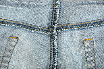 Texture of blue jeans from the inside with yellow thread seams